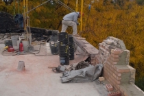 A worker constructing a building wall